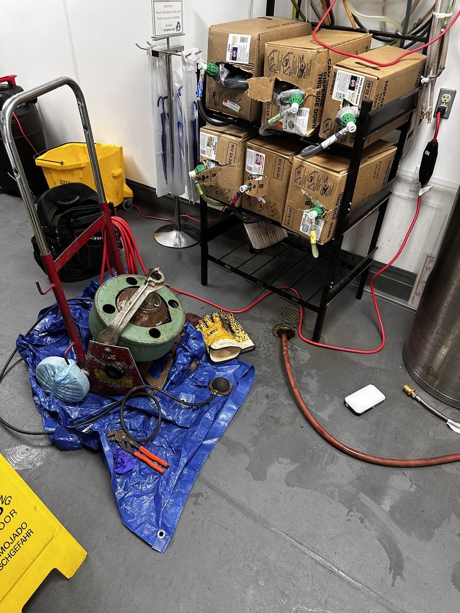 Main Line drain machine set up on a tarp for a commercial kitchen drain job